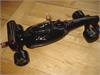 SIGNED BY SIR STIRLING MOSS, WINE BOTTLE IN THE SHAPE OF FORMULA 1 CAR SIGNED "STIRLING" WHICH IS VERY RARE