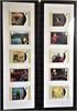 Framed card collection featuring reproduced postage stamps of Elton John album covers