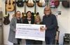 Stacey Addisson from E.A.C.H. accepting the Live Aid 2019 cheque at the Music Hut, with Rebbecca, Chris and Barry